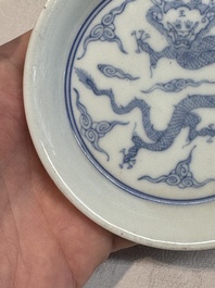 A Chinese monochrome 'anhua' 'dragon' bowl and a blue and white 'dragon' saucer, 18/19th C.