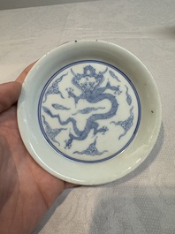 A Chinese monochrome 'anhua' 'dragon' bowl and a blue and white 'dragon' saucer, 18/19th C.