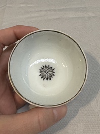 Two Chinese gilt-decorated grisaille 'European subject' cups and saucers, Qianlong