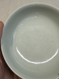 A Chinese monochrome 'anhua' 'dragon' bowl and a blue and white 'dragon' saucer, 18/19th C.