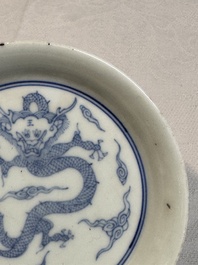 A Chinese monochrome 'anhua' 'dragon' bowl and a blue and white 'dragon' saucer, 18/19th C.