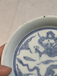 A Chinese monochrome 'anhua' 'dragon' bowl and a blue and white 'dragon' saucer, 18/19th C.