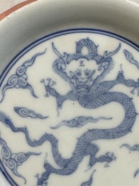 A Chinese monochrome 'anhua' 'dragon' bowl and a blue and white 'dragon' saucer, 18/19th C.