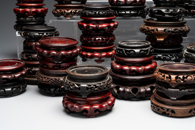 A large collection of 87 Chinese wooden stands, 19/20th C.