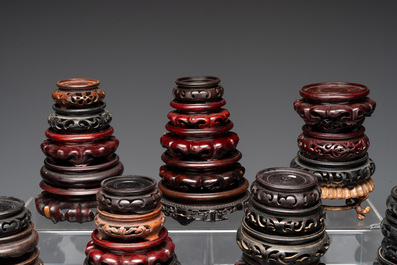 A large collection of 87 Chinese wooden stands, 19/20th C.