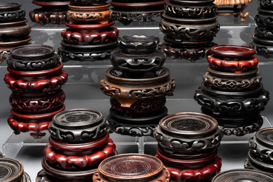 A large collection of 87 Chinese wooden stands, 19/20th C.
