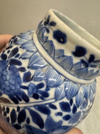 A pair of Chinese blue and white vases and covers with floral design, Kangxi