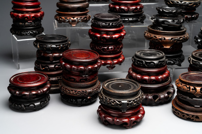 A large collection of 87 Chinese wooden stands, 19/20th C.