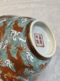 A Chinese fencai gilt-decorated 'dragons on waves' bowl and cover, Jiaqing mark, 19th C.