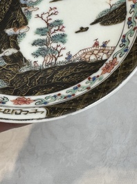 A Chinese famille rose and grisaille 'mountainous landscape' cup and saucer, Yongzheng