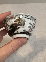 A Chinese famille rose and grisaille 'mountainous landscape' cup and saucer, Yongzheng