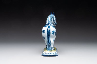 A fine pair of blue and white Dutch Delft horses on a green base, 18th C.