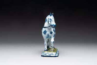 A fine pair of blue and white Dutch Delft horses on a green base, 18th C.