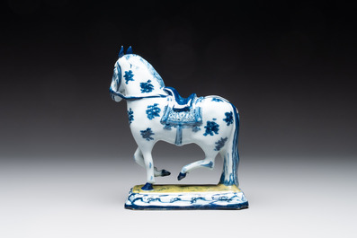 A fine pair of blue and white Dutch Delft horses on a green base, 18th C.