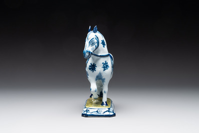 A fine pair of blue and white Dutch Delft horses on a green base, 18th C.