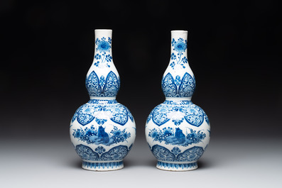 A pair of blue and white Dutch Delft double gourd vases with leopards, late 17th C.