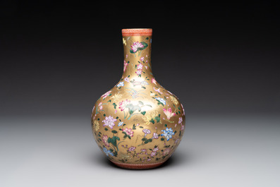 A Chinese gilt-ground famille rose vase with floral design, Qianlong mark and possibly of the period