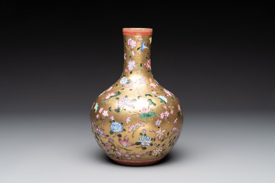 A Chinese gilt-ground famille rose vase with floral design, Qianlong mark and possibly of the period