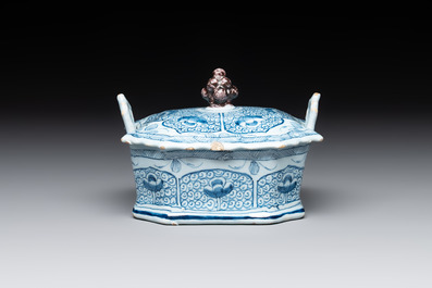 A blue and white Dutch Delft butter tub and cover with a berry finial, 18th C.