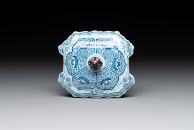 A blue and white Dutch Delft butter tub and cover with a berry finial, 18th C.
