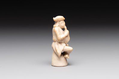 A carved alabaster figure of a seated bagpiper, Low Countries, possibly 17th C.