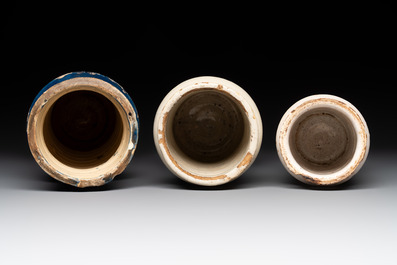 A blue-glazed albarello and two white-glazed albarelli, Spain, 17th C.