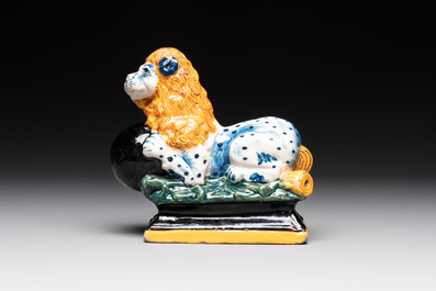 A rare black-ground polychrome Dutch Delft model of a lion with a ball, 18th C.