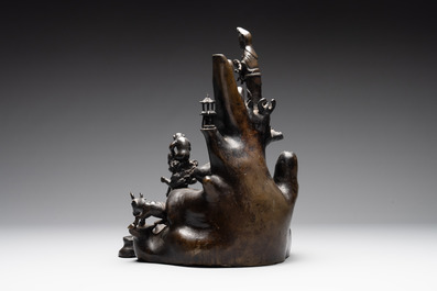 A rare Chinese bronze group depicting two immortals and various animals in a mountainous landscape, Ming