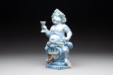 A polychrome Dutch Delft table fountain in the shape of Bacchus on a barrel, early 18th C.