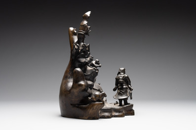 A rare Chinese bronze group depicting two immortals and various animals in a mountainous landscape, Ming