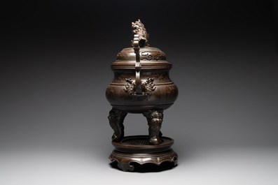 A massive Vietnamese copper- and silver-inlaid 'Buddhist lion' censer and cover on stand, 19th C.