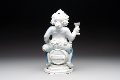 A polychrome Dutch Delft table fountain in the shape of Bacchus on a barrel, early 18th C.