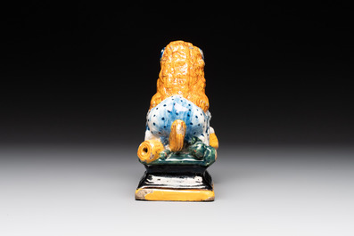 A rare black-ground polychrome Dutch Delft model of a lion with a ball, 18th C.