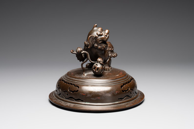 A massive Vietnamese copper- and silver-inlaid 'Buddhist lion' censer and cover on stand, 19th C.