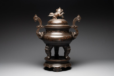 A massive Vietnamese copper- and silver-inlaid 'Buddhist lion' censer and cover on stand, 19th C.