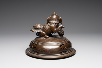 A massive Vietnamese copper- and silver-inlaid 'Buddhist lion' censer and cover on stand, 19th C.