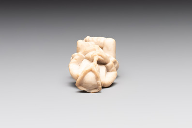 A carved alabaster figure of a seated bagpiper, Low Countries, possibly 17th C.