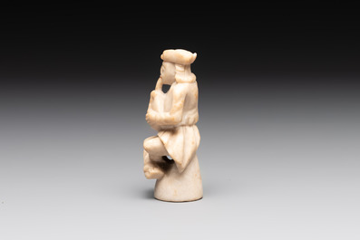 A carved alabaster figure of a seated bagpiper, Low Countries, possibly 17th C.
