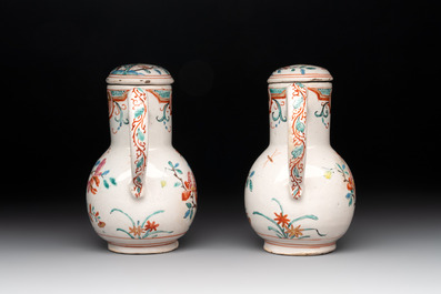 A rare polychrome Dutch Delft petit feu cruet set of two jugs and covers on a stand, 18th C.