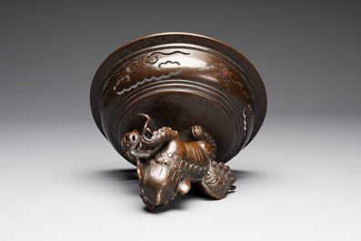 A massive Vietnamese copper- and silver-inlaid 'Buddhist lion' censer and cover on stand, 19th C.