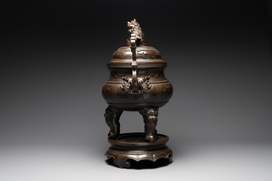 A massive Vietnamese copper- and silver-inlaid 'Buddhist lion' censer and cover on stand, 19th C.