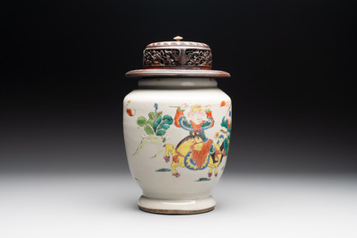 A Chinese famille rose 'warrior on horseback' vase and a wooden cover, Yongzheng/Qianlong