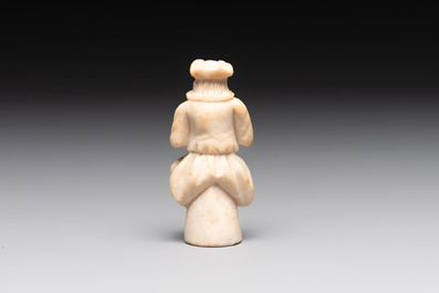 A carved alabaster figure of a seated bagpiper, Low Countries, possibly 17th C.