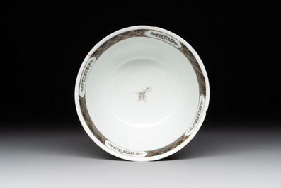 A Chinese famille rose and grisaille 'mountainous landscape' cup and saucer, Yongzheng