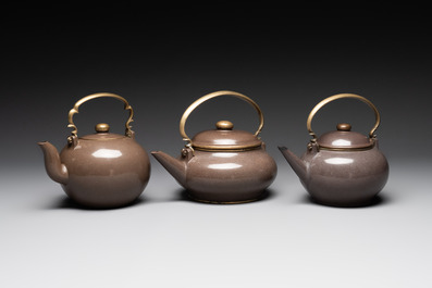 Three Chinese Thai market polished Yixing stoneware teapots with brass mounts, 19th C.
