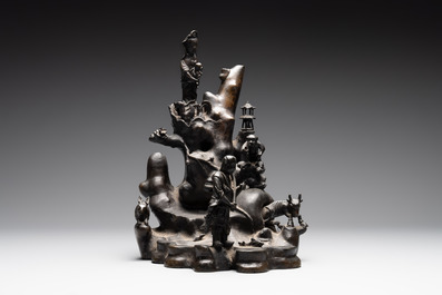 A rare Chinese bronze group depicting two immortals and various animals in a mountainous landscape, Ming