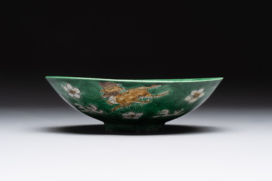 A Chinese verte biscuit 'animals among waves' bowl and a wooden stand, Jiajing mark, Kangxi