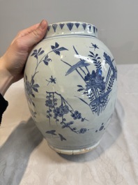 A Chinese blue and white vase with floral design and wooden cover, Transitional period