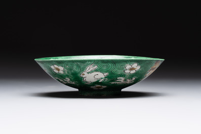 A Chinese verte biscuit 'animals among waves' bowl and a wooden stand, Jiajing mark, Kangxi