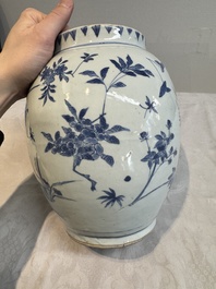 A Chinese blue and white vase with floral design and wooden cover, Transitional period